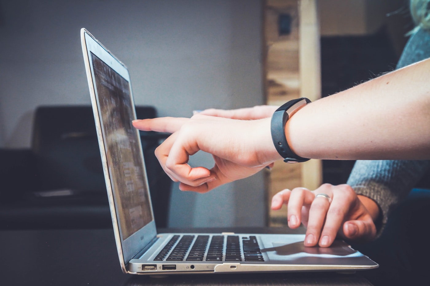 Two people working together at a laptop