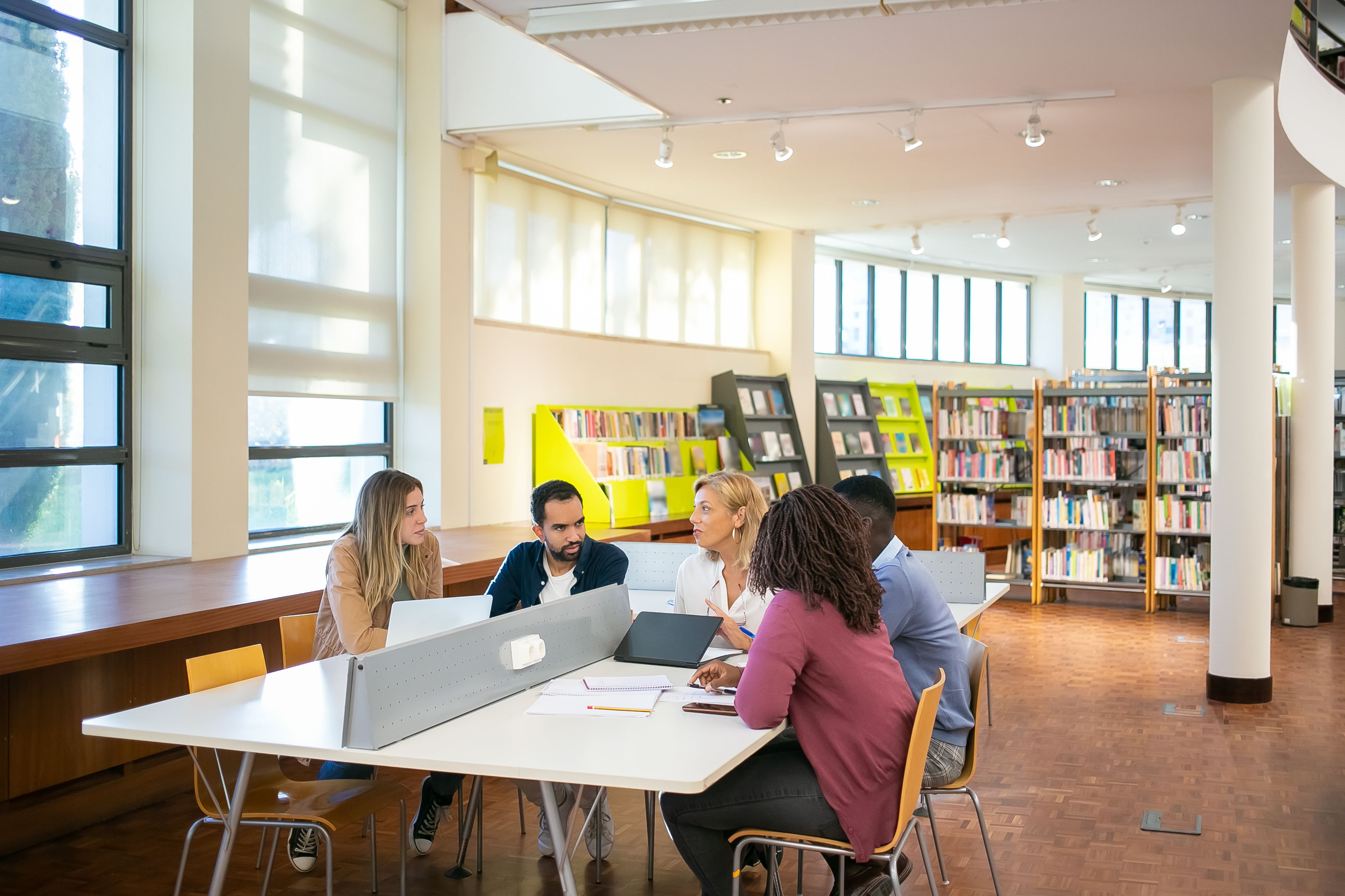 International students working together in a bright university library