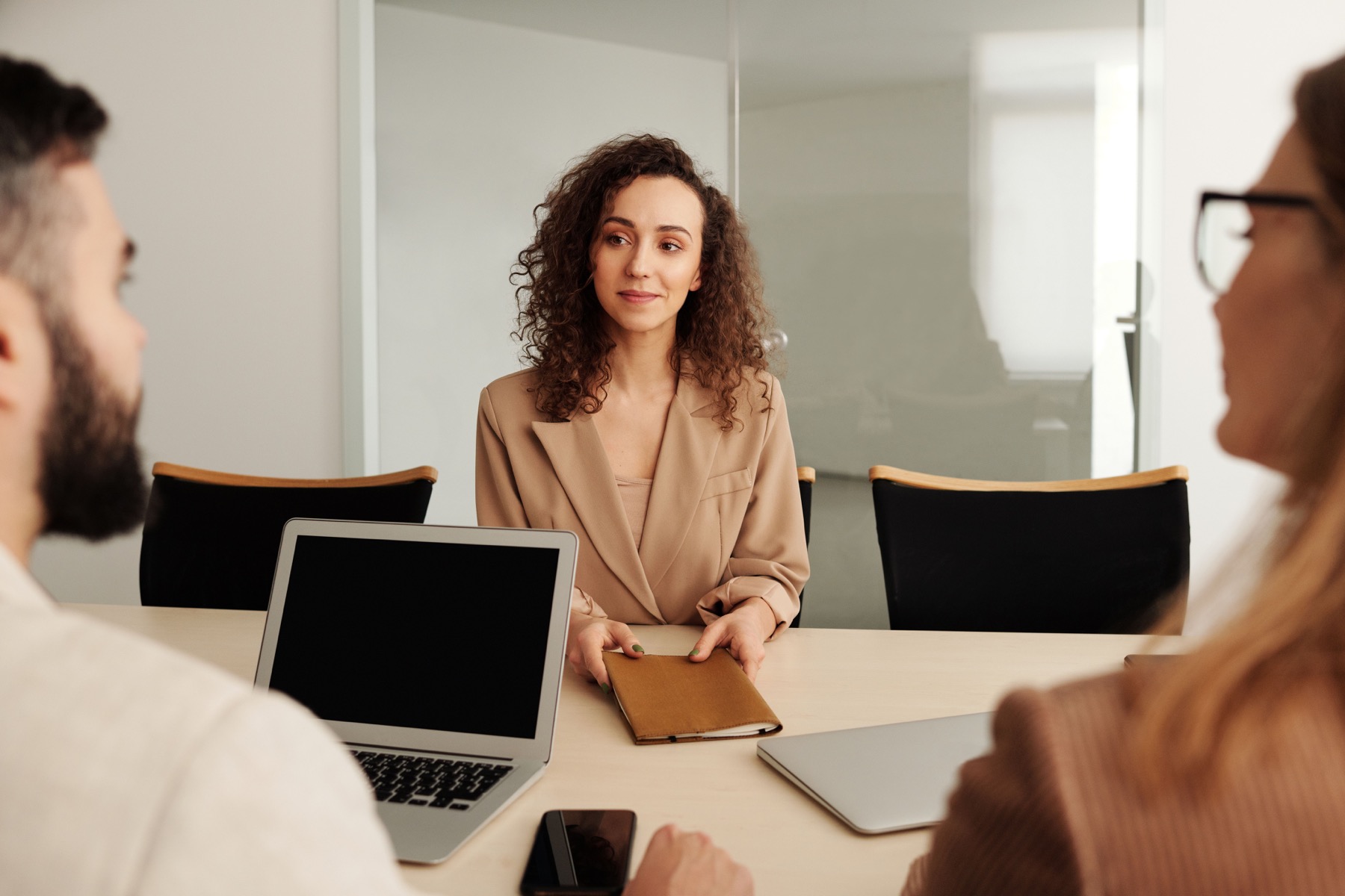 Graduate discussing a CV with a recruiter during a job interview