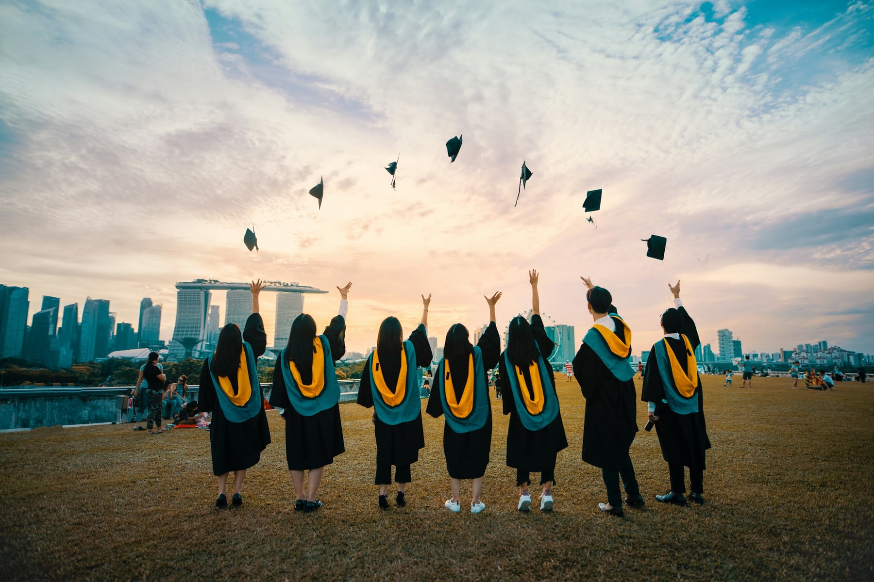Graduates celebrating by throwing their academic caps into the air