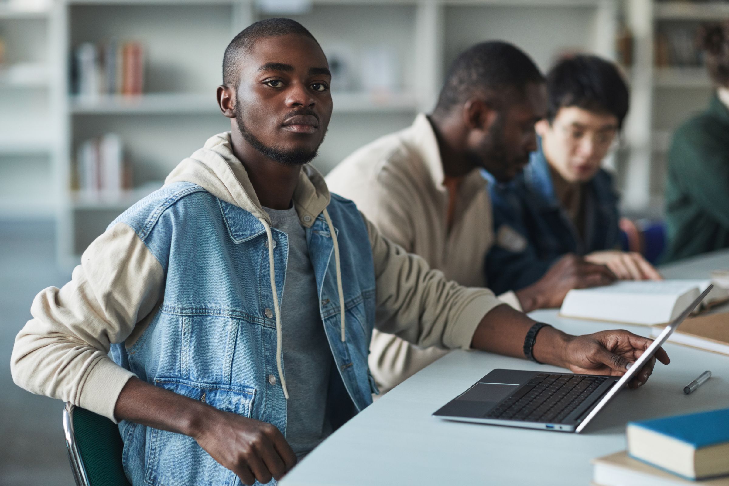 Students working on laptops in a university library