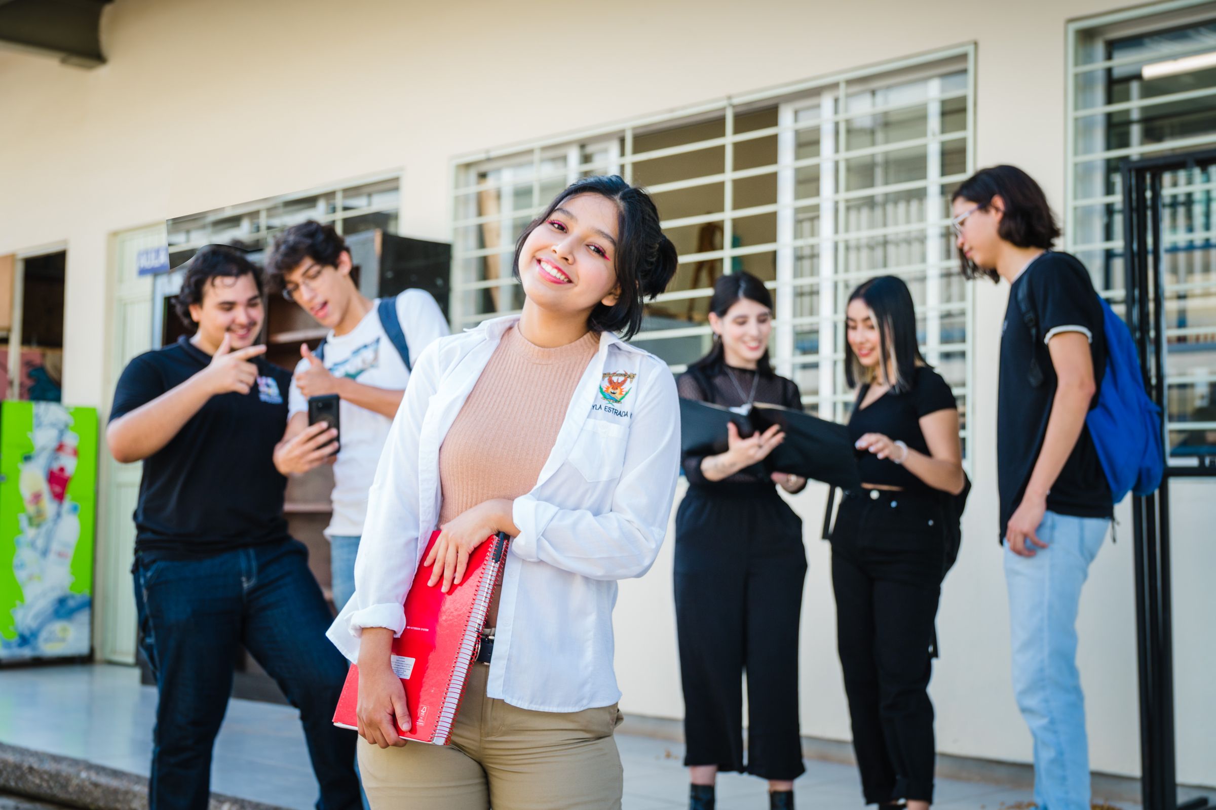 A group of students discussing courses and study choices outside a university building