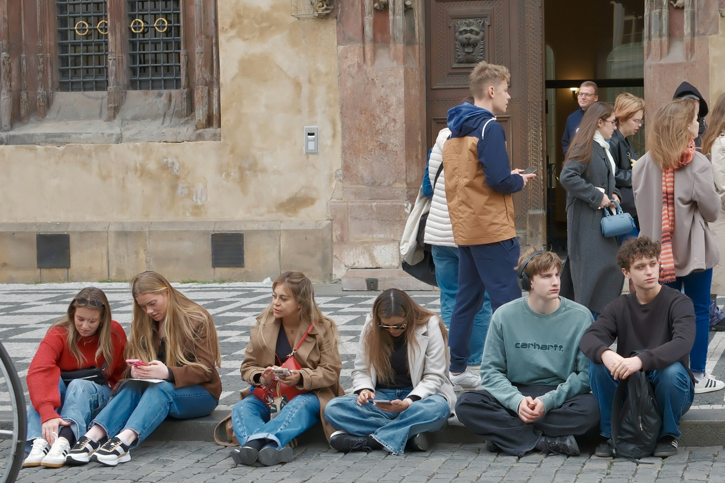 A group of students outside a historic university building in Prague, Czechia